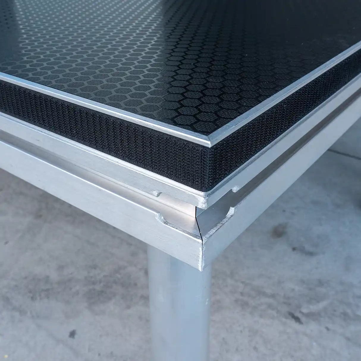 Titan AV Stage Deck corner with guardrail channel and hook & loop for stage skirting.